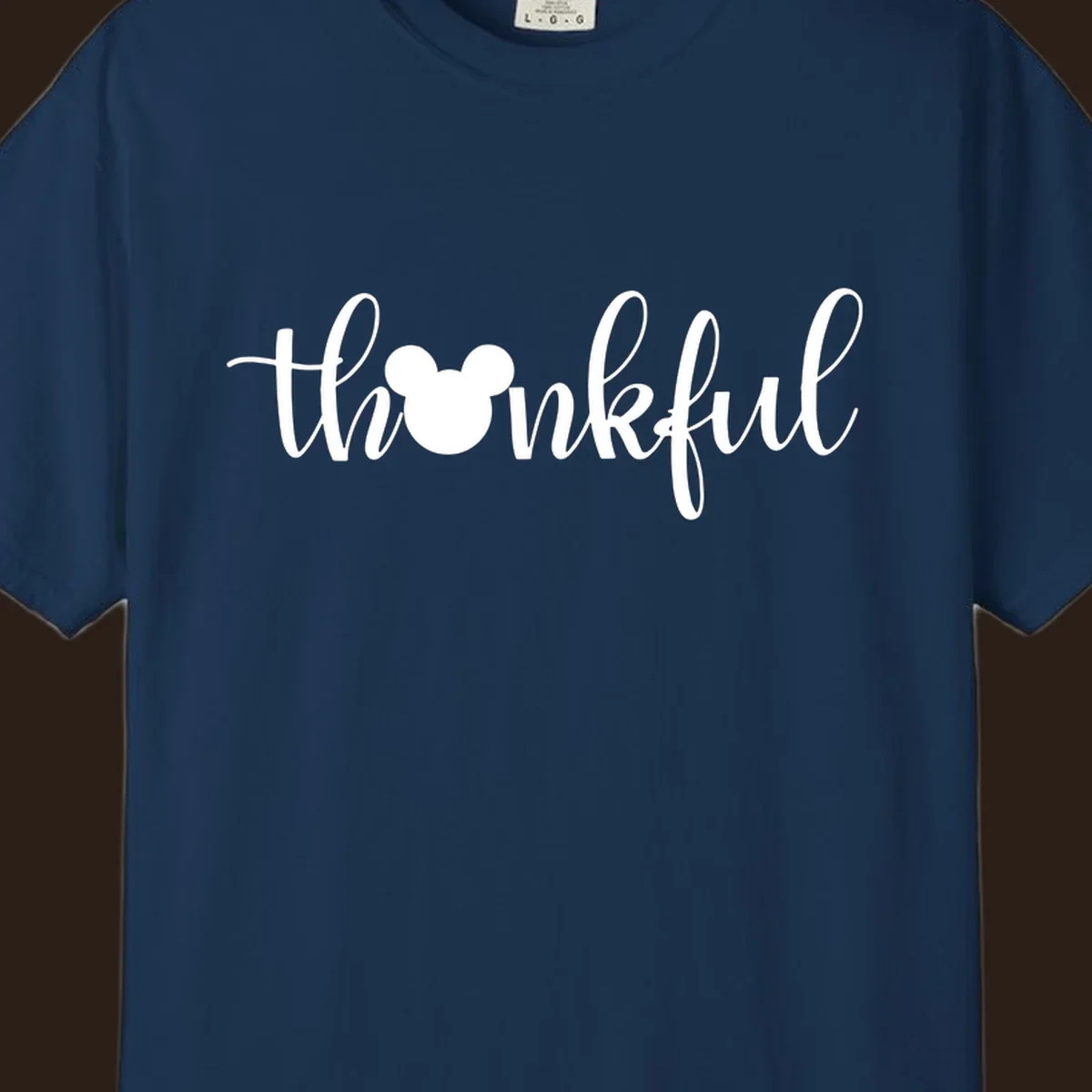 Script text 'thankful' with Mickey Mouse head silhouette replacing the 'o', in white and black variants.