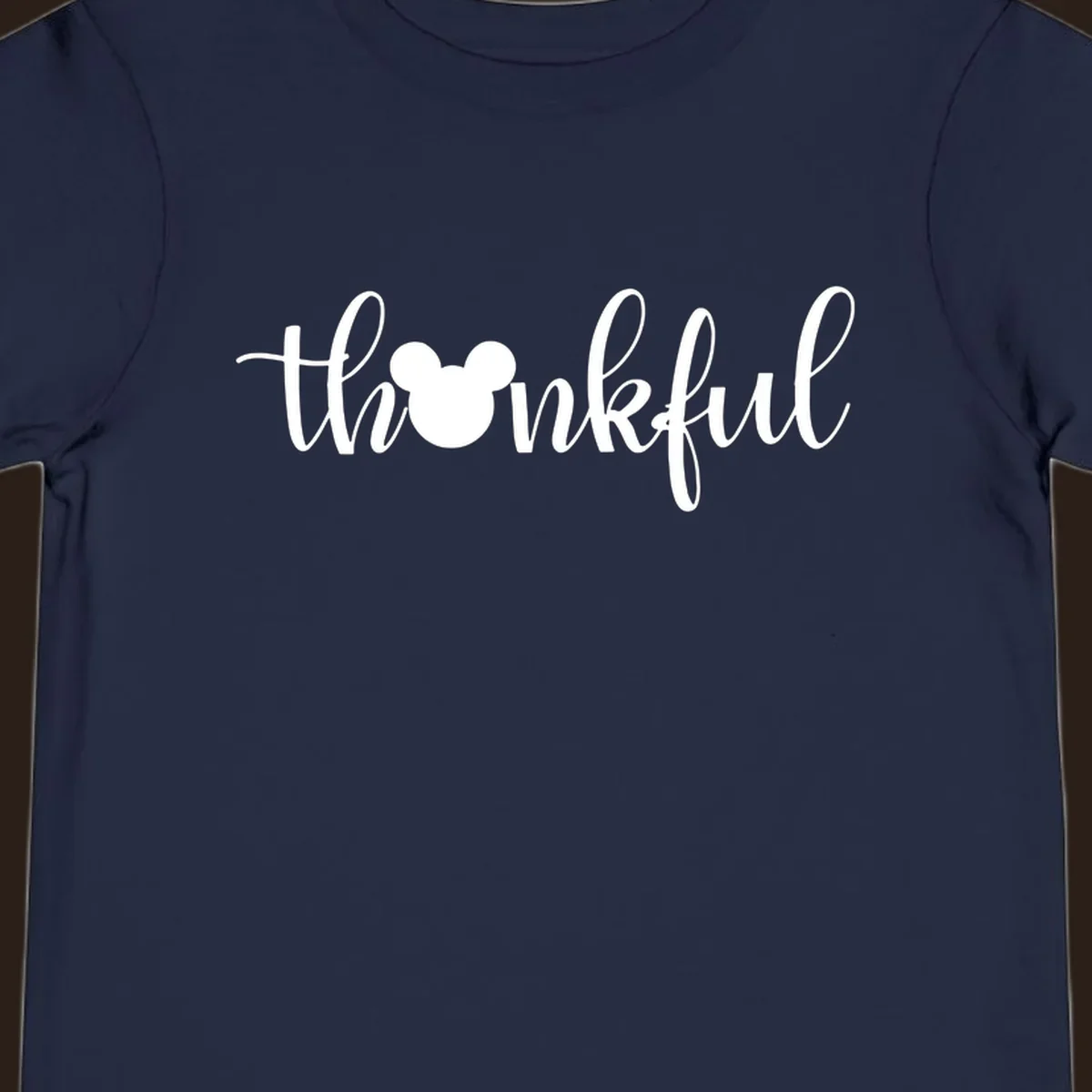 Script text 'thankful' with Mickey Mouse head silhouette replacing the 'o', in white and black variants.