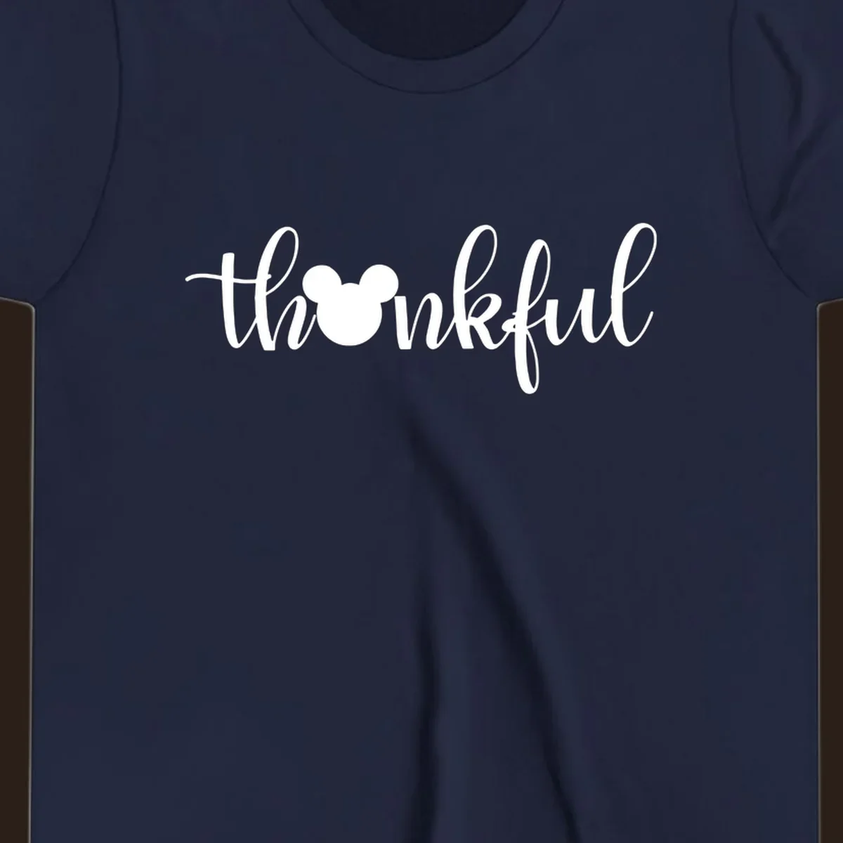 Script text 'thankful' with Mickey Mouse head silhouette replacing the 'o', in white and black variants.