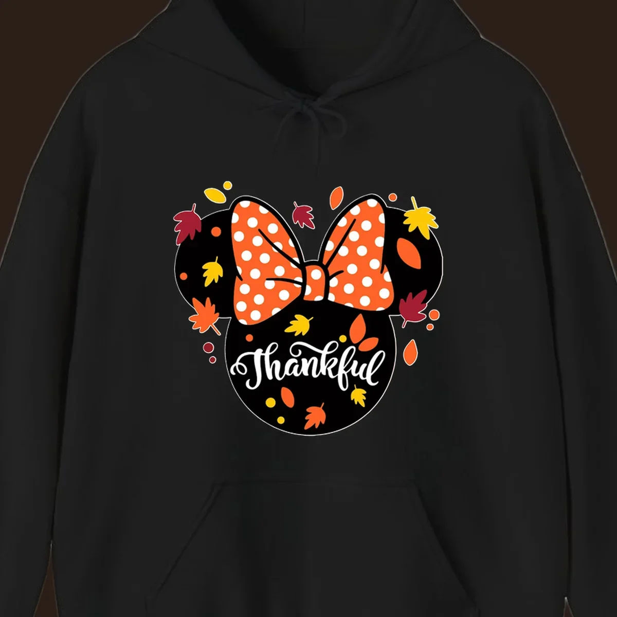 Minnie Mouse silhouette with polka dot bow and fall leaves, text reads Thankful.