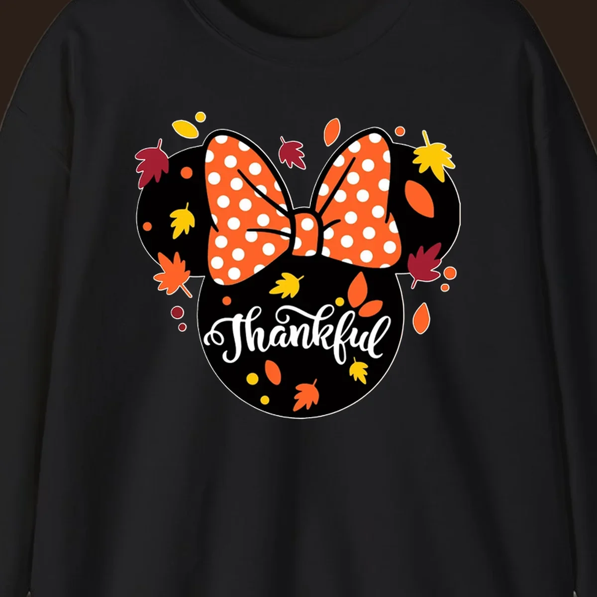 Minnie Mouse silhouette with polka dot bow and fall leaves, text reads Thankful.