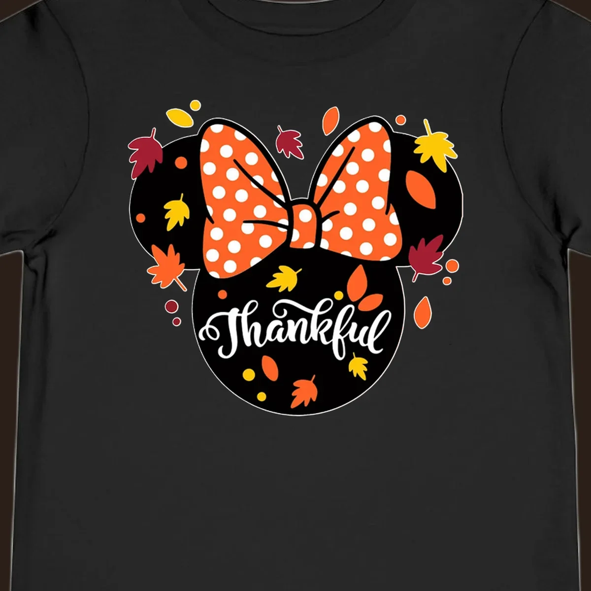 Minnie Mouse silhouette with polka dot bow and fall leaves, text reads Thankful.