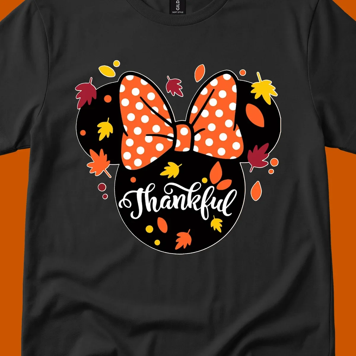 Minnie Mouse silhouette with polka dot bow and fall leaves, text reads Thankful.
