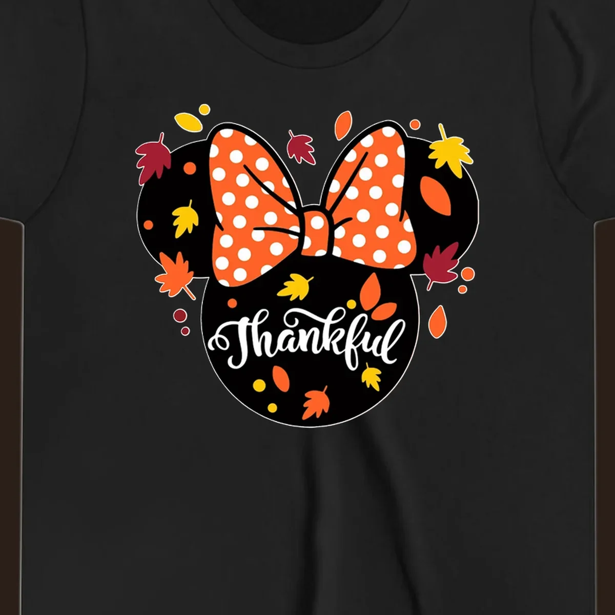 Minnie Mouse silhouette with polka dot bow and fall leaves, text reads Thankful.