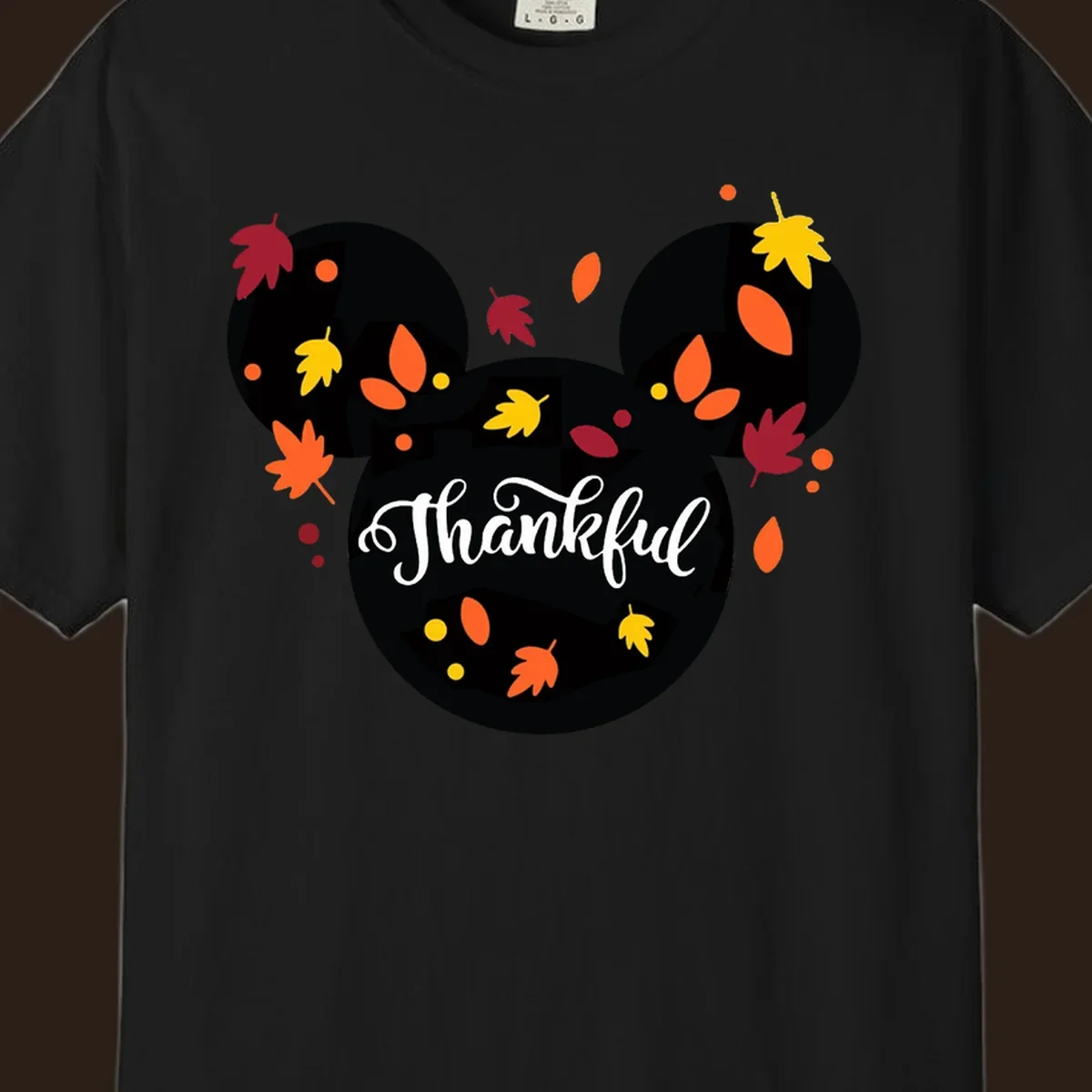 Mickey mouse head silhouette with 'Thankful' text and fall leaves, for thanksgiving shirts.