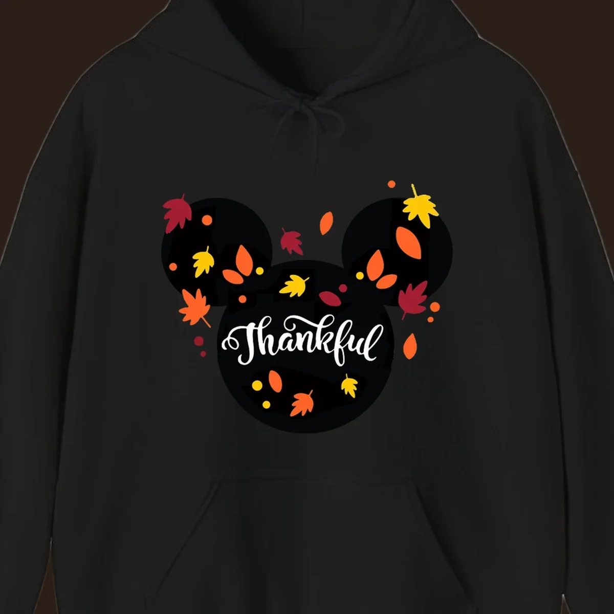 Mickey mouse head silhouette with 'Thankful' text and fall leaves, for thanksgiving shirts.