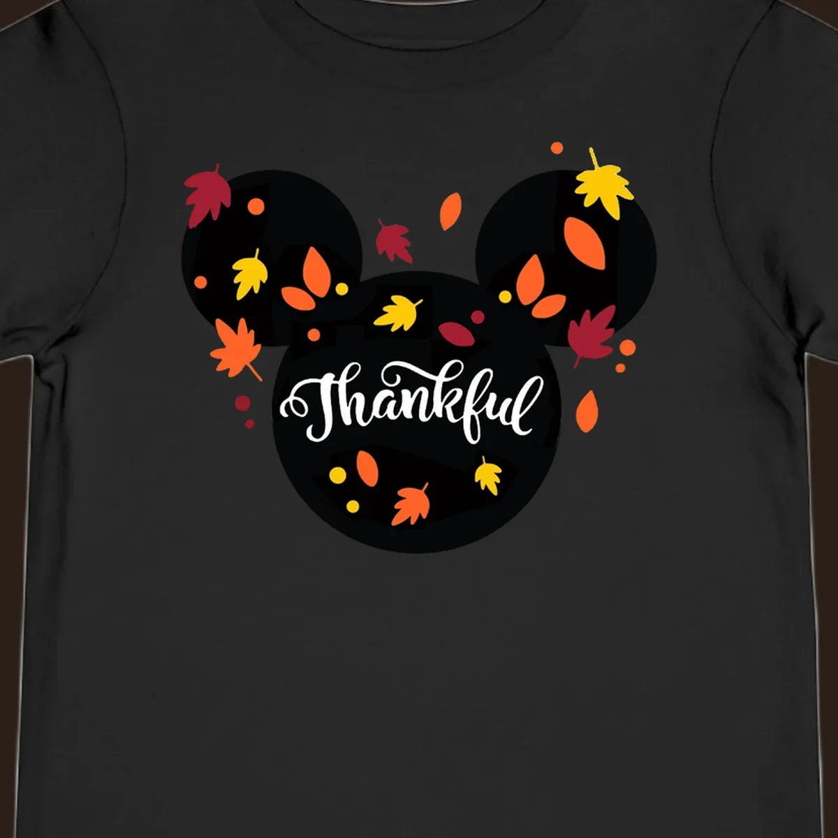Mickey mouse head silhouette with 'Thankful' text and fall leaves, for thanksgiving shirts.