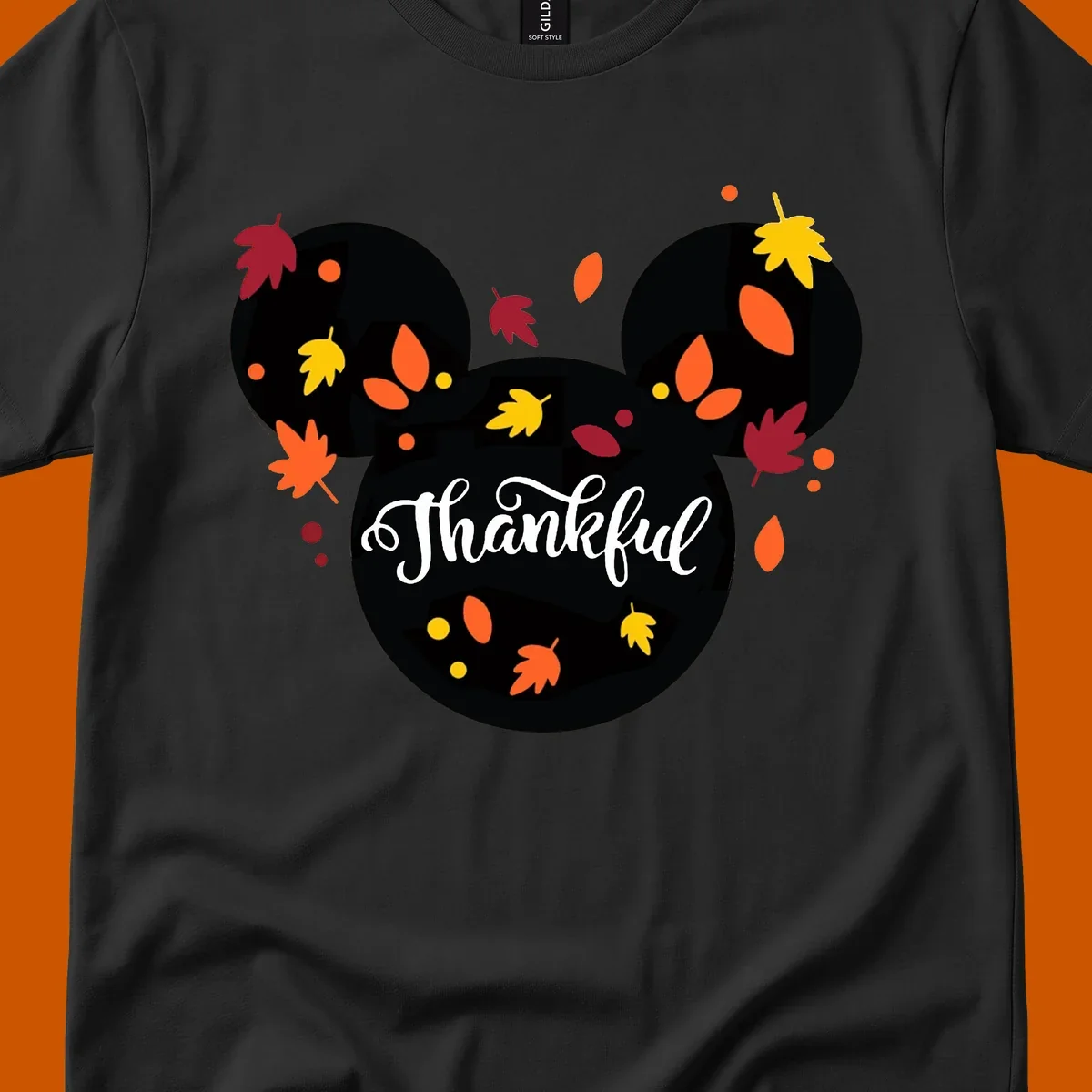 Mickey mouse head silhouette with 'Thankful' text and fall leaves, for thanksgiving shirts.