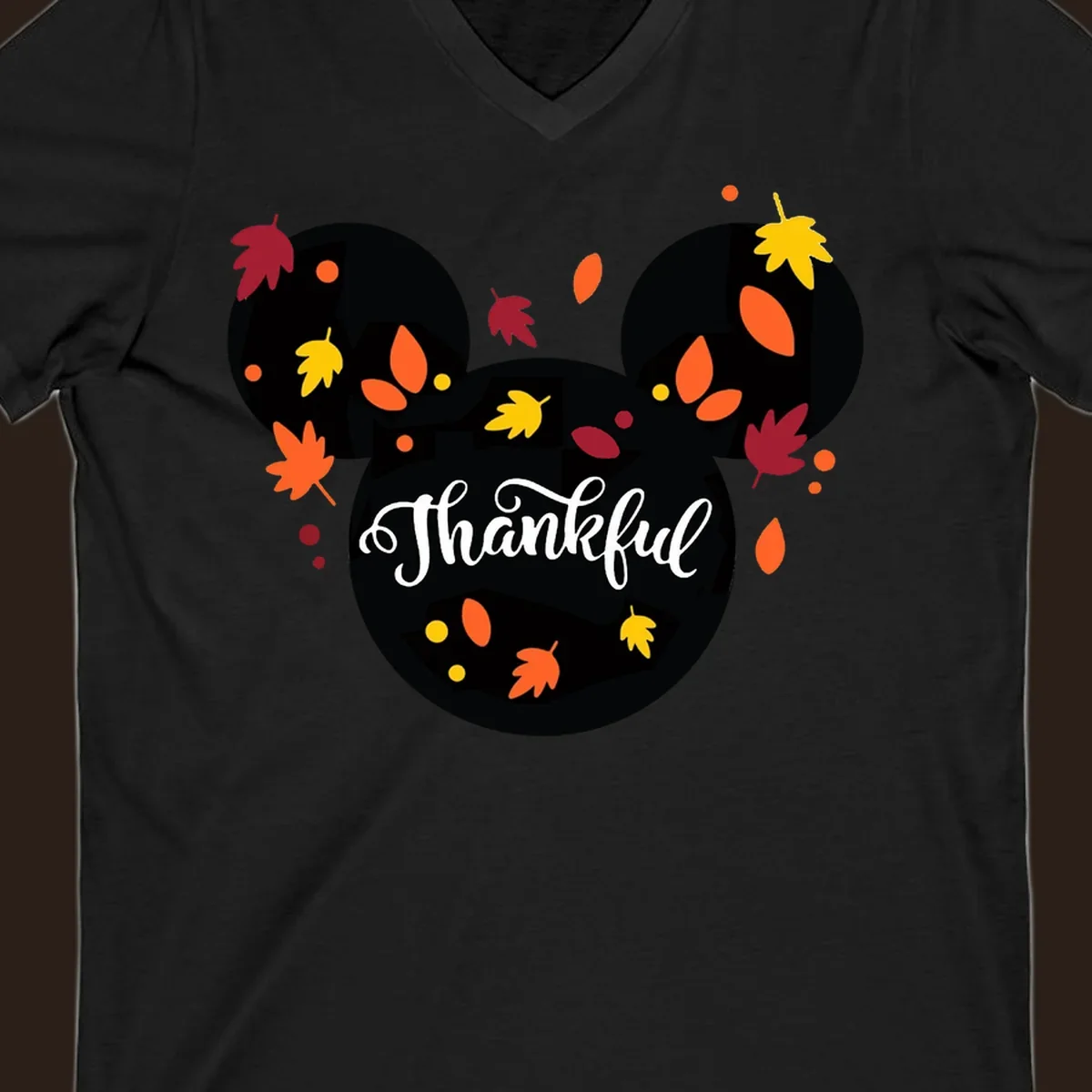 Mickey mouse head silhouette with 'Thankful' text and fall leaves, for thanksgiving shirts.