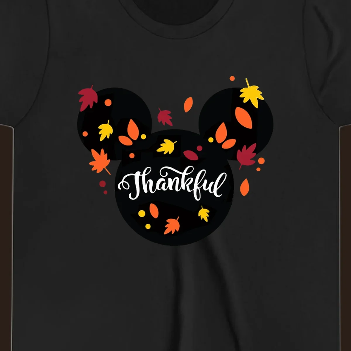 Mickey mouse head silhouette with 'Thankful' text and fall leaves, for thanksgiving shirts.
