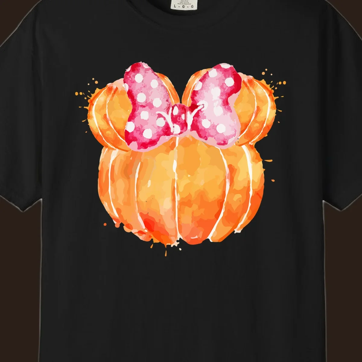 Watercolor illustration of two orange pumpkins shaped like Minnie Mouse ears with a pink polka dot bow.