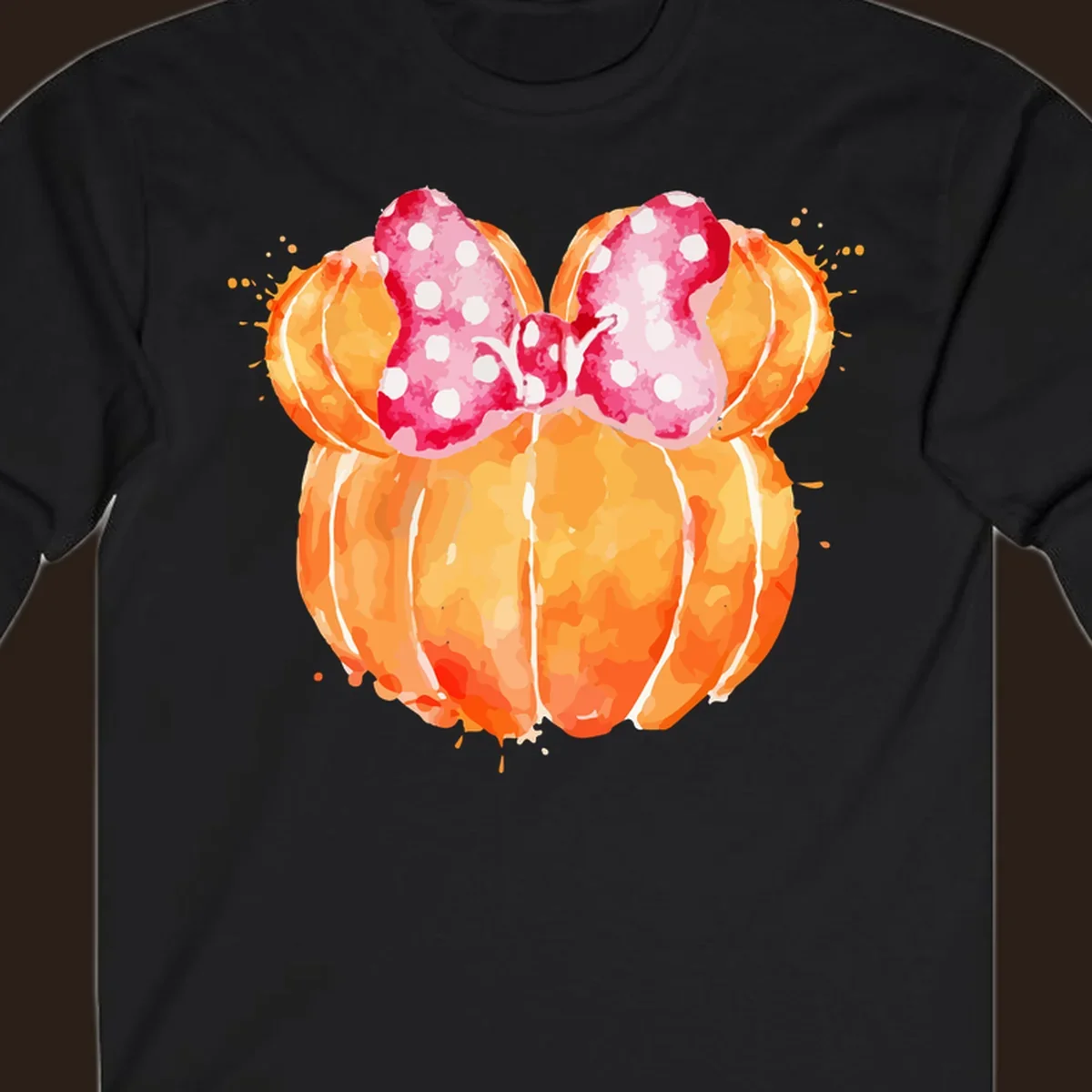 Watercolor illustration of two orange pumpkins shaped like Minnie Mouse ears with a pink polka dot bow.