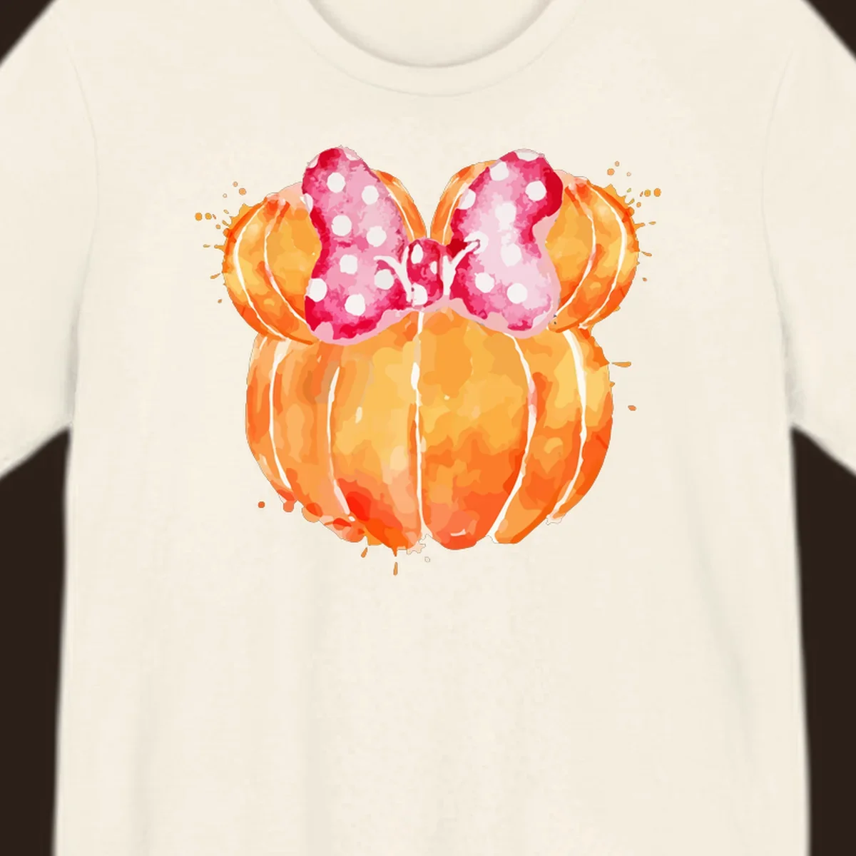 Watercolor illustration of two orange pumpkins shaped like Minnie Mouse ears with a pink polka dot bow.