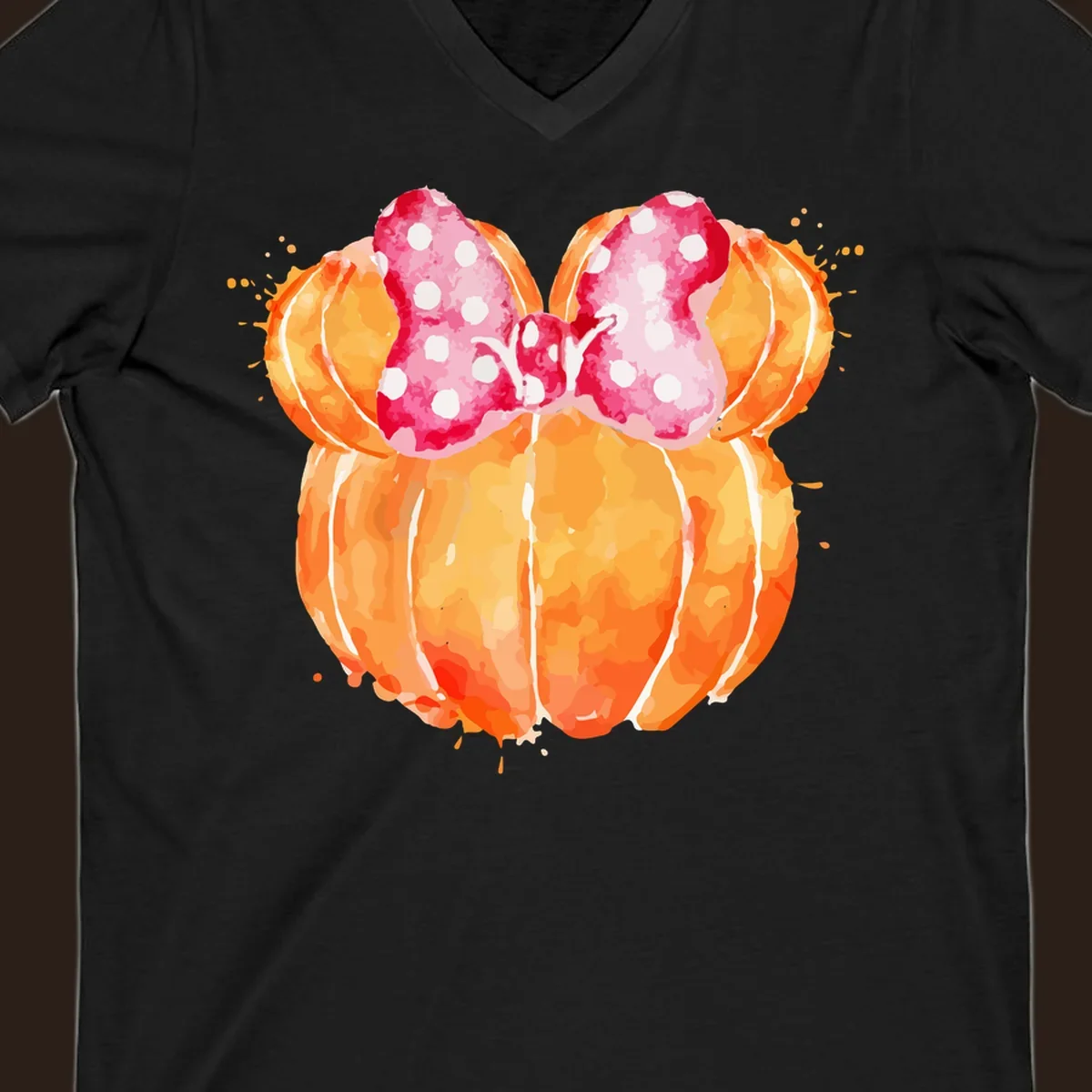 Watercolor illustration of two orange pumpkins shaped like Minnie Mouse ears with a pink polka dot bow.