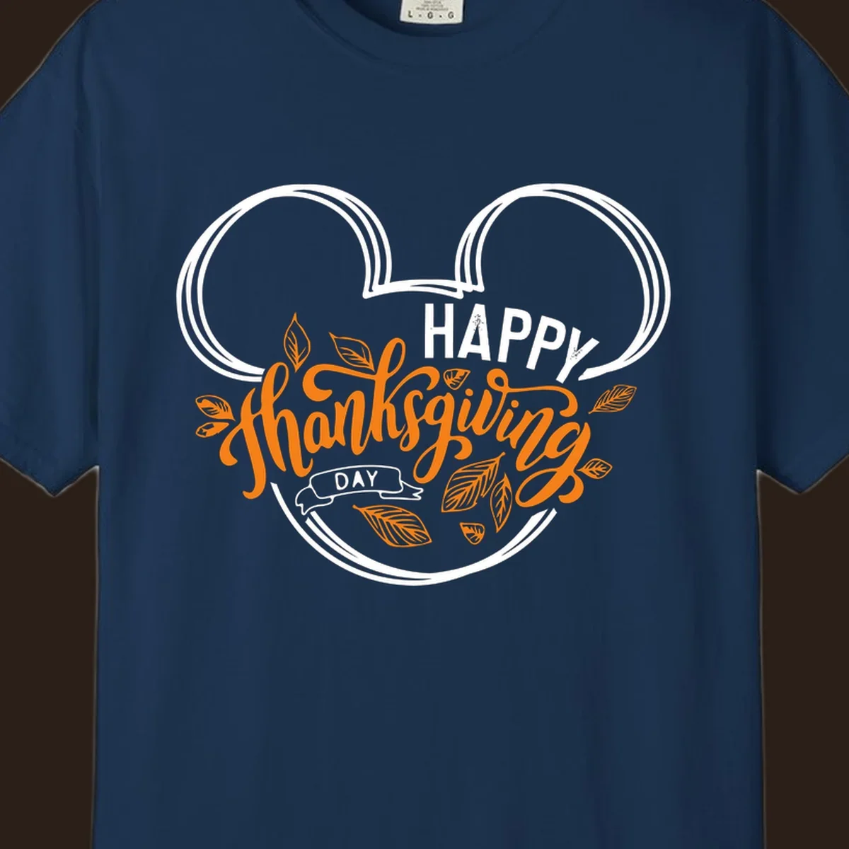Happy Thanksgiving Day text with Mickey Mouse ears and fall leaves.