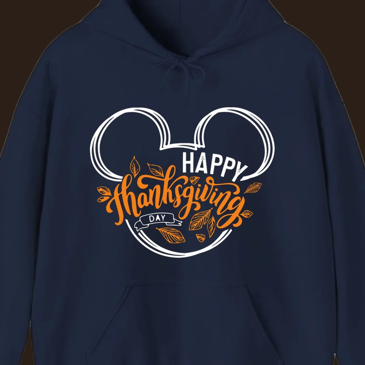 Happy Thanksgiving Day text with Mickey Mouse ears and fall leaves.