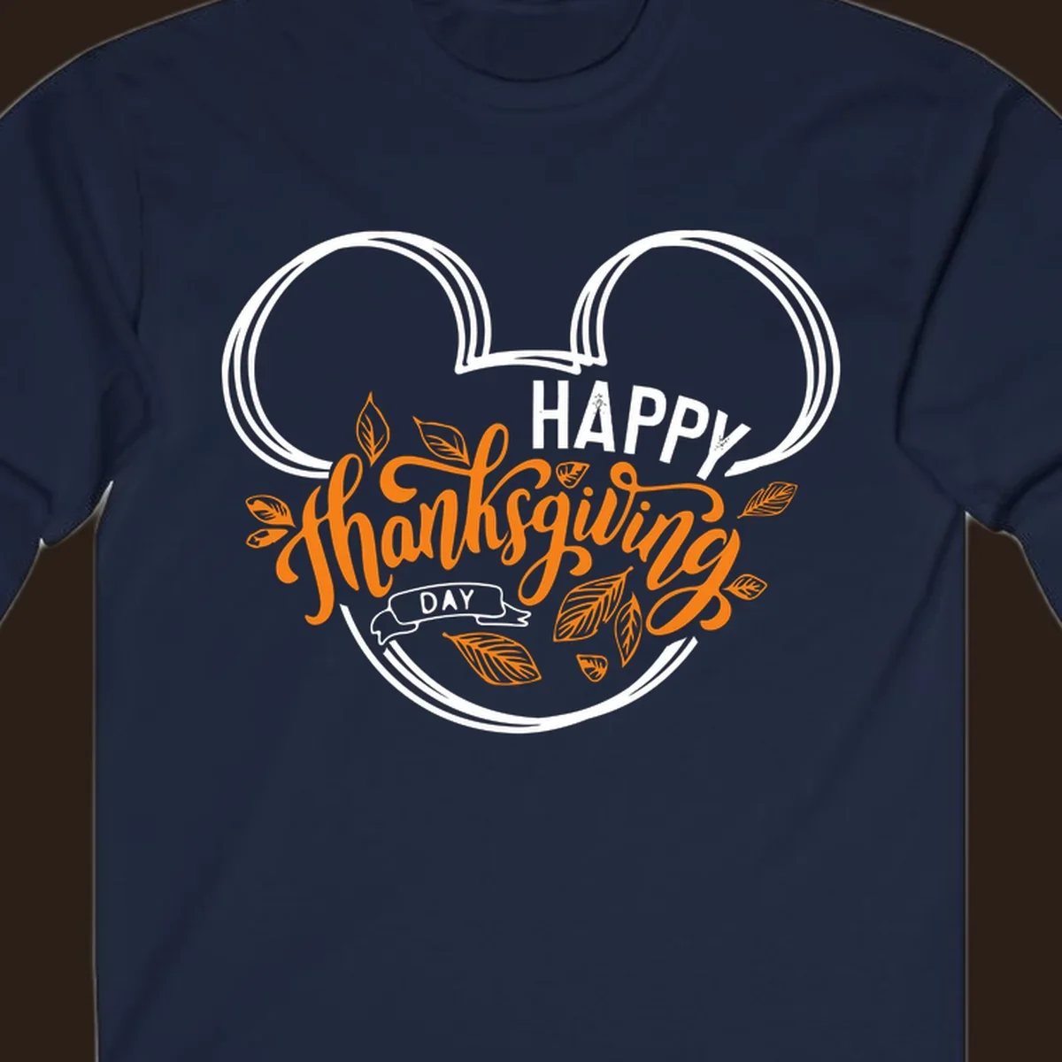 Happy Thanksgiving Day text with Mickey Mouse ears and fall leaves.