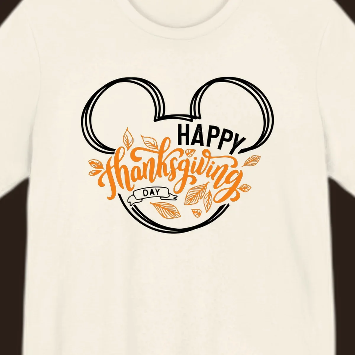 Happy Thanksgiving Day text with Mickey Mouse ears and fall leaves.