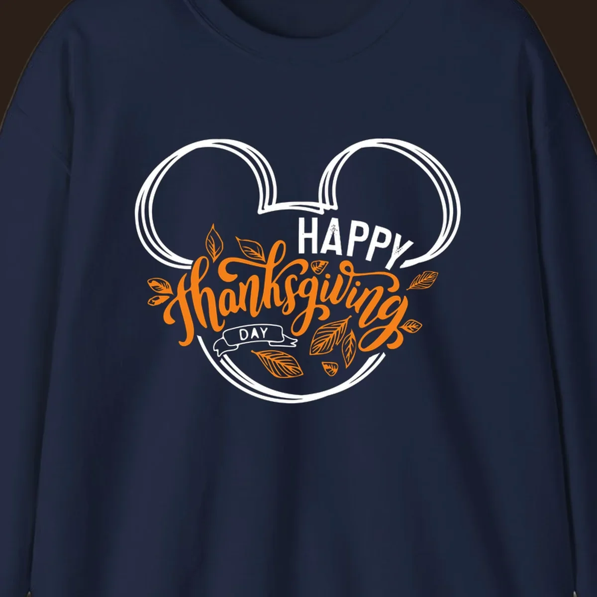 Happy Thanksgiving Day text with Mickey Mouse ears and fall leaves.