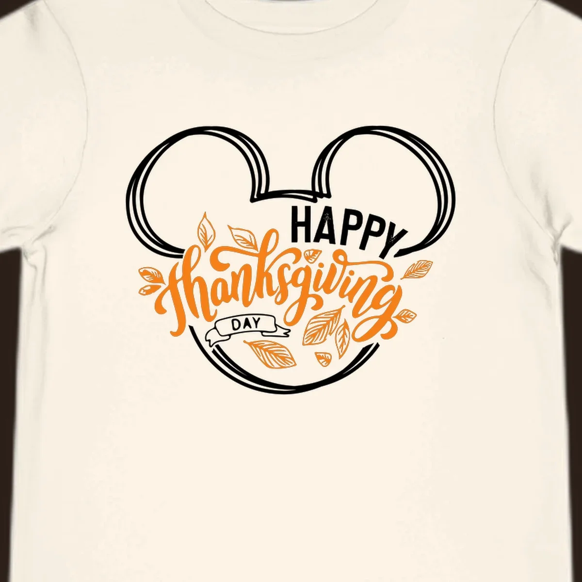 Happy Thanksgiving Day text with Mickey Mouse ears and fall leaves.
