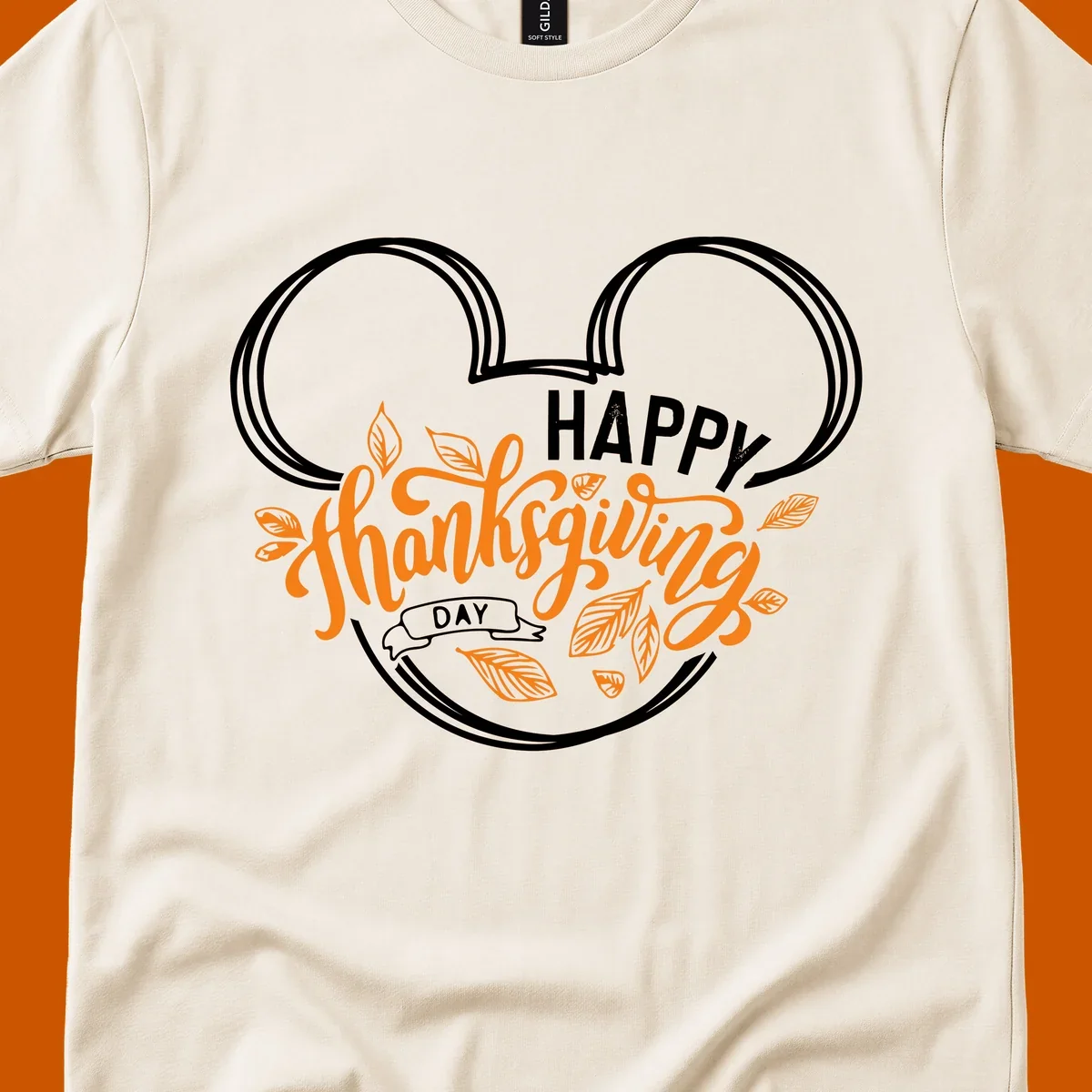 Happy Thanksgiving Day text with Mickey Mouse ears and fall leaves.