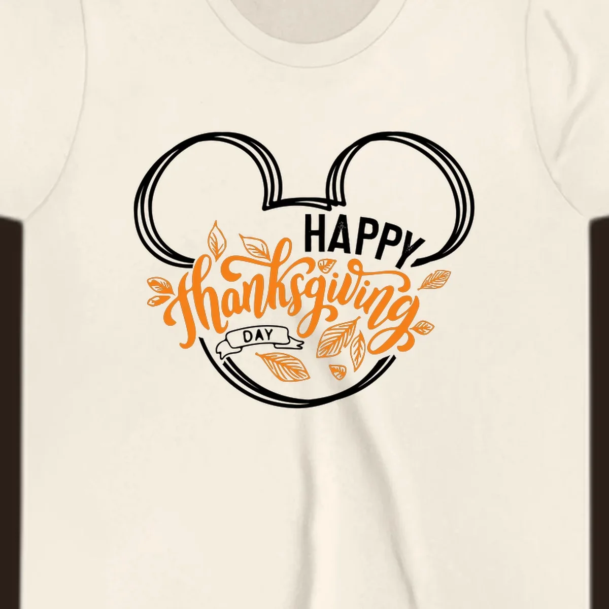 Happy Thanksgiving Day text with Mickey Mouse ears and fall leaves.