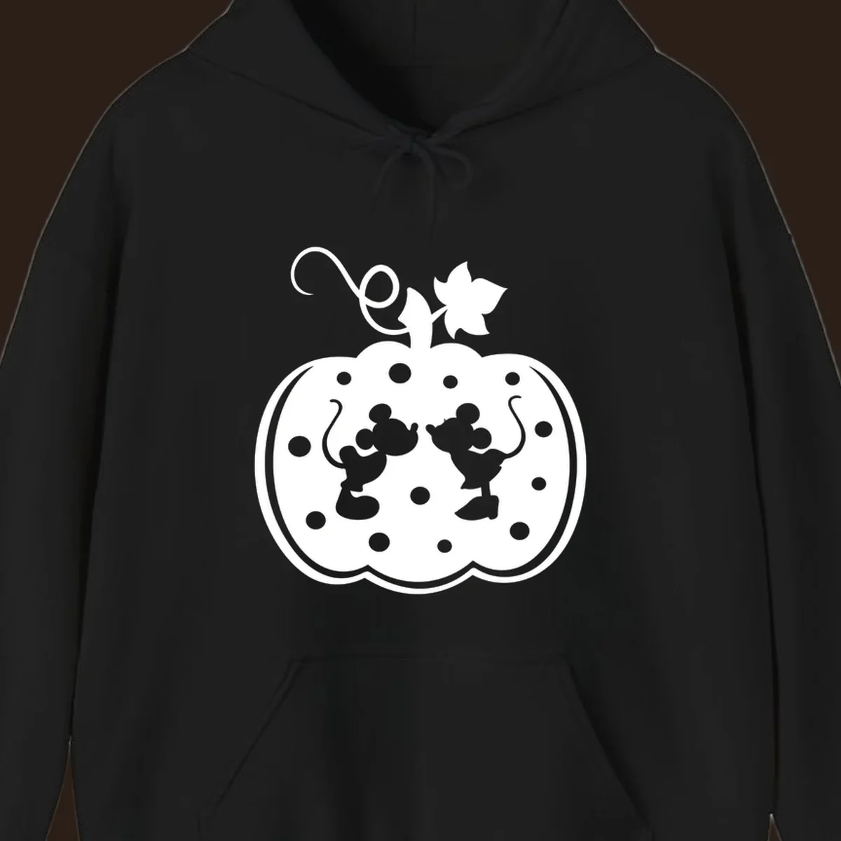 Mickey and Minnie Mouse kissing inside a pumpkin silhouette, with polka dots. Mickey-Minnie-pumpkin.