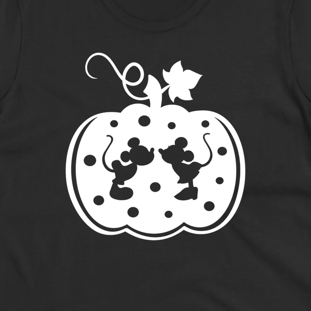 Mickey and Minnie Mouse kissing inside a pumpkin silhouette, with polka dots. Mickey-Minnie-pumpkin.