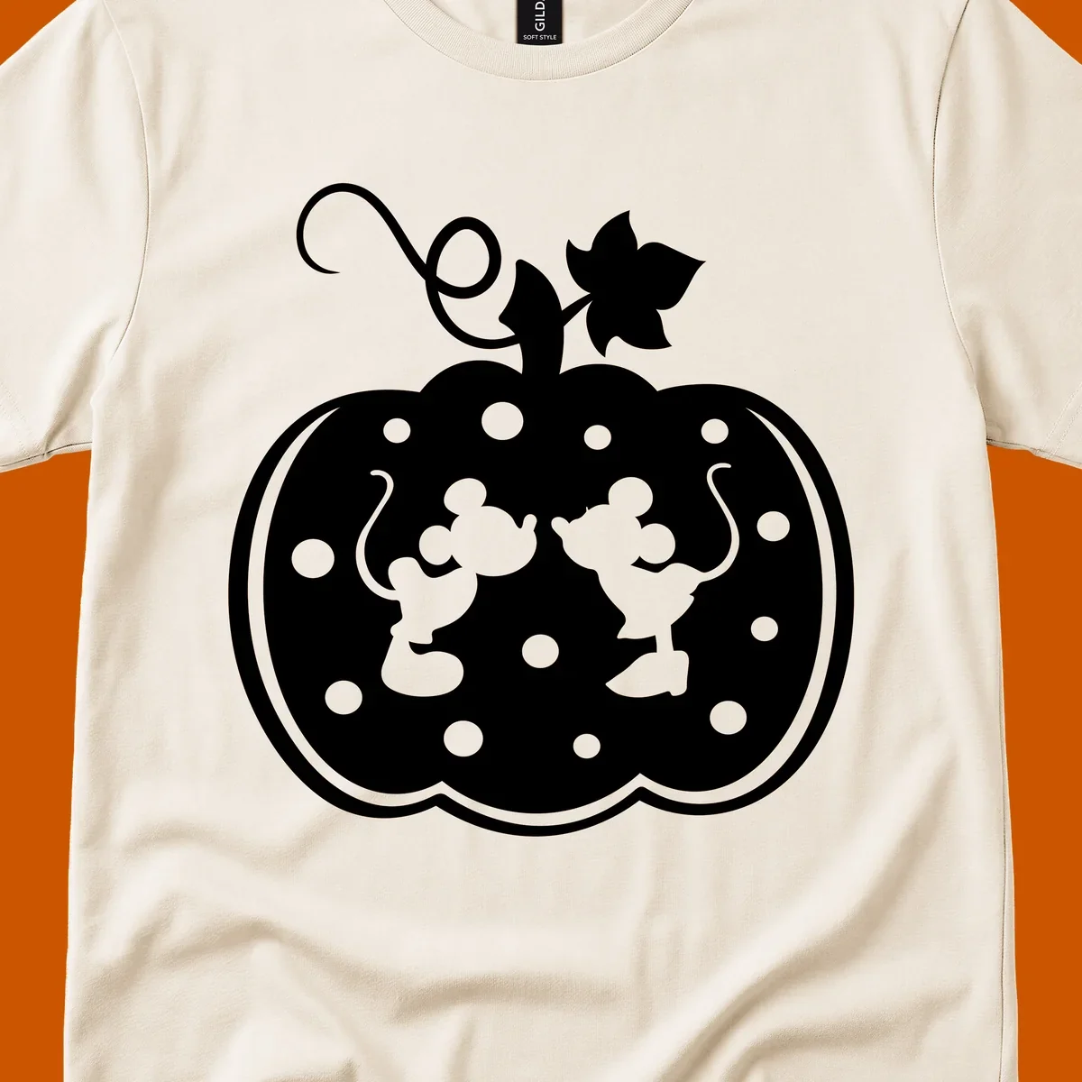 Mickey and Minnie Mouse kissing inside a pumpkin silhouette, with polka dots. Mickey-Minnie-pumpkin.