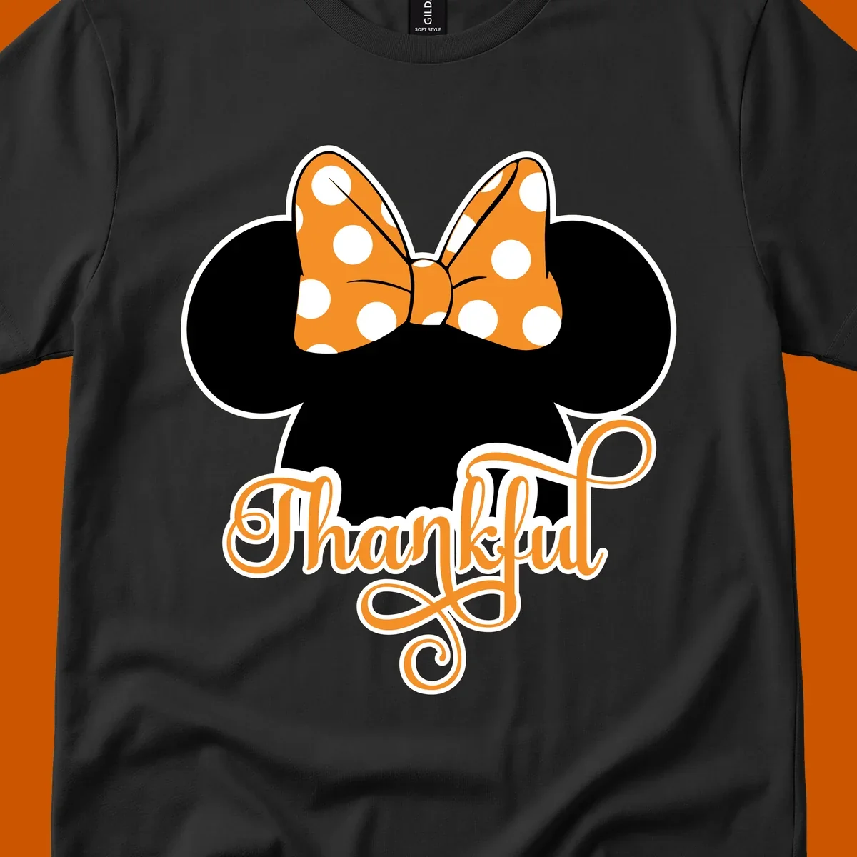 Minnie Mouse ears with orange polka dot bow and "Thankful" text, perfect for Thanksgiving.