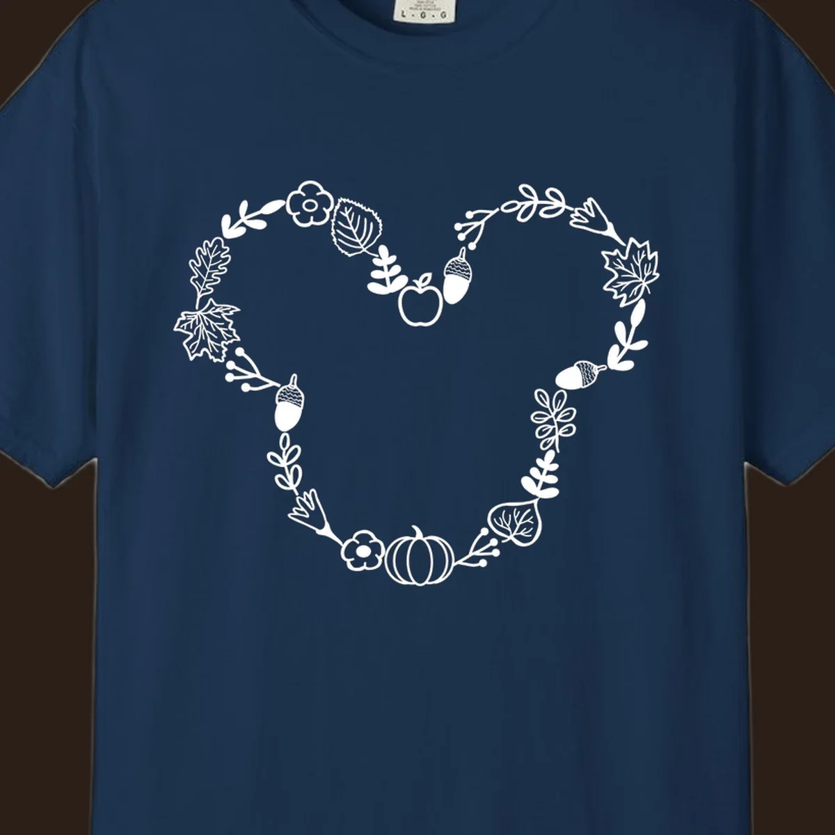 Heart shaped autumn wreath with leaves, acorns, pumpkin, and flowers. Outline design.