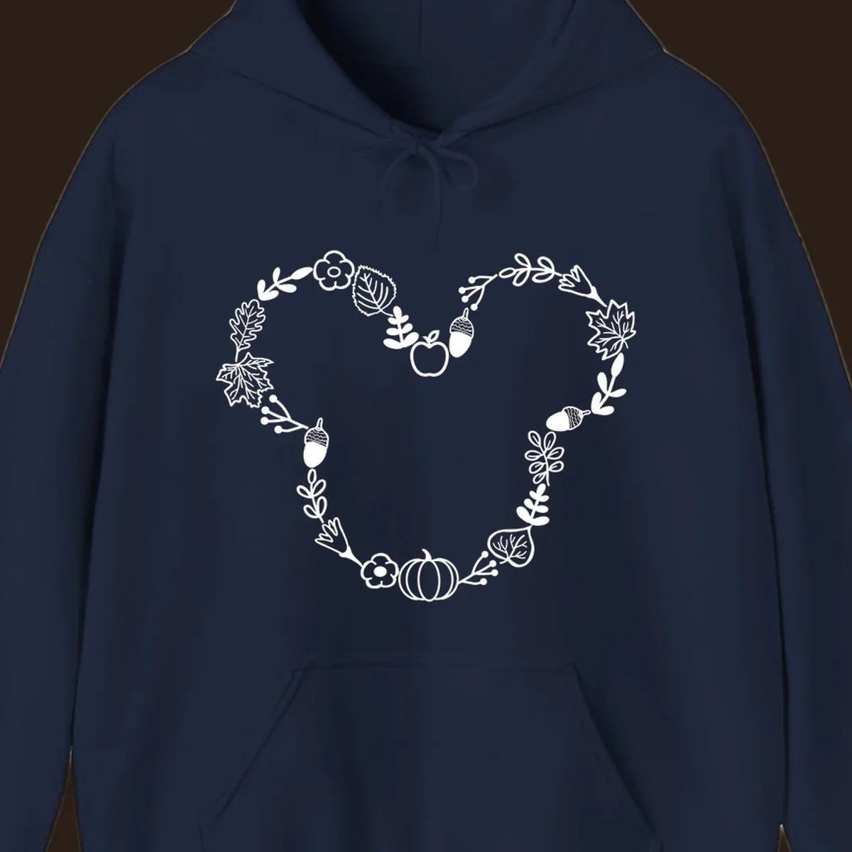 Heart shaped autumn wreath with leaves, acorns, pumpkin, and flowers. Outline design.