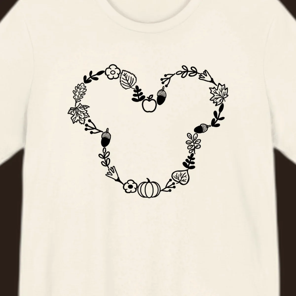 Heart shaped autumn wreath with leaves, acorns, pumpkin, and flowers. Outline design.