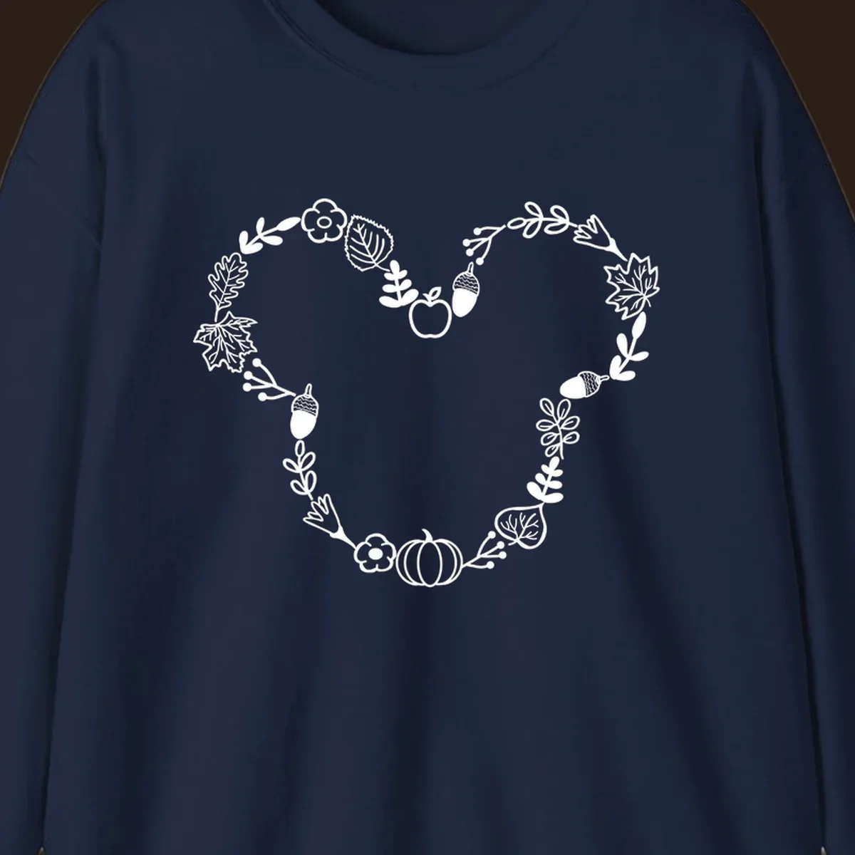 Heart shaped autumn wreath with leaves, acorns, pumpkin, and flowers. Outline design.