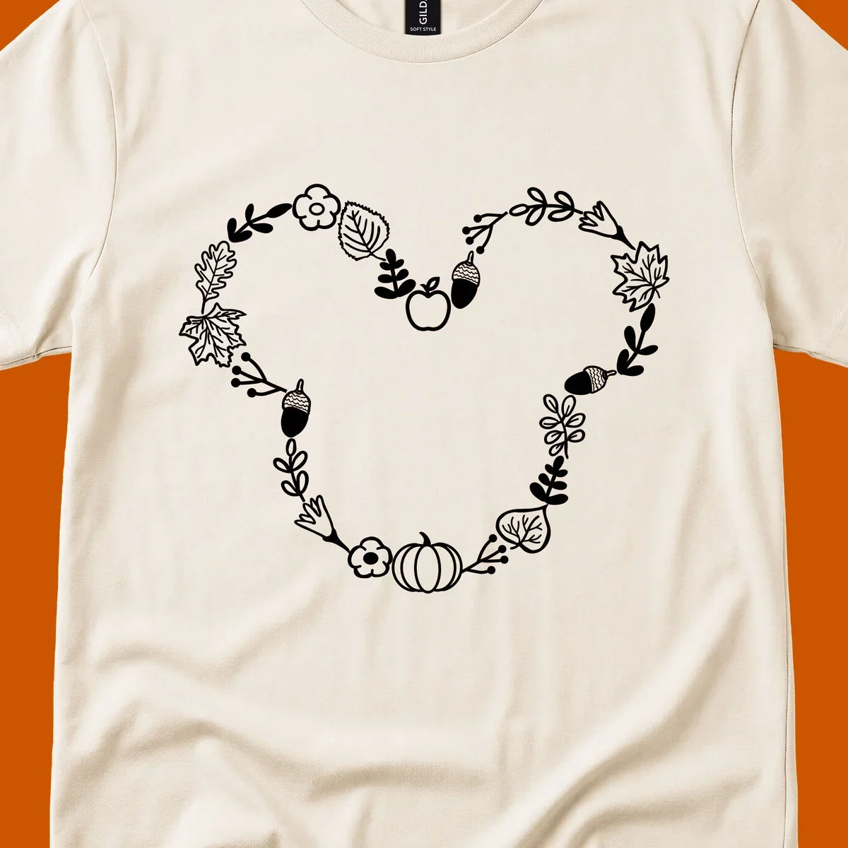 Heart shaped autumn wreath with leaves, acorns, pumpkin, and flowers. Outline design.