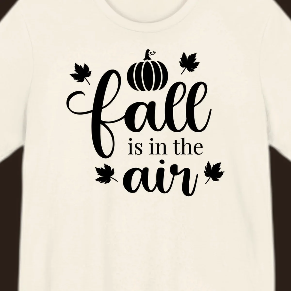 Fall is in the air phrase with pumpkin and maple leaves graphic.