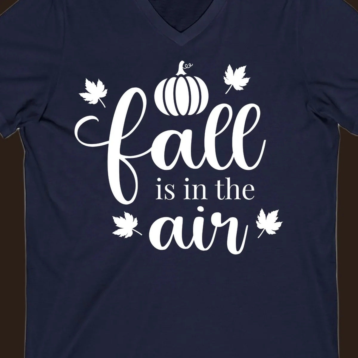 Fall is in the air phrase with pumpkin and maple leaves graphic.