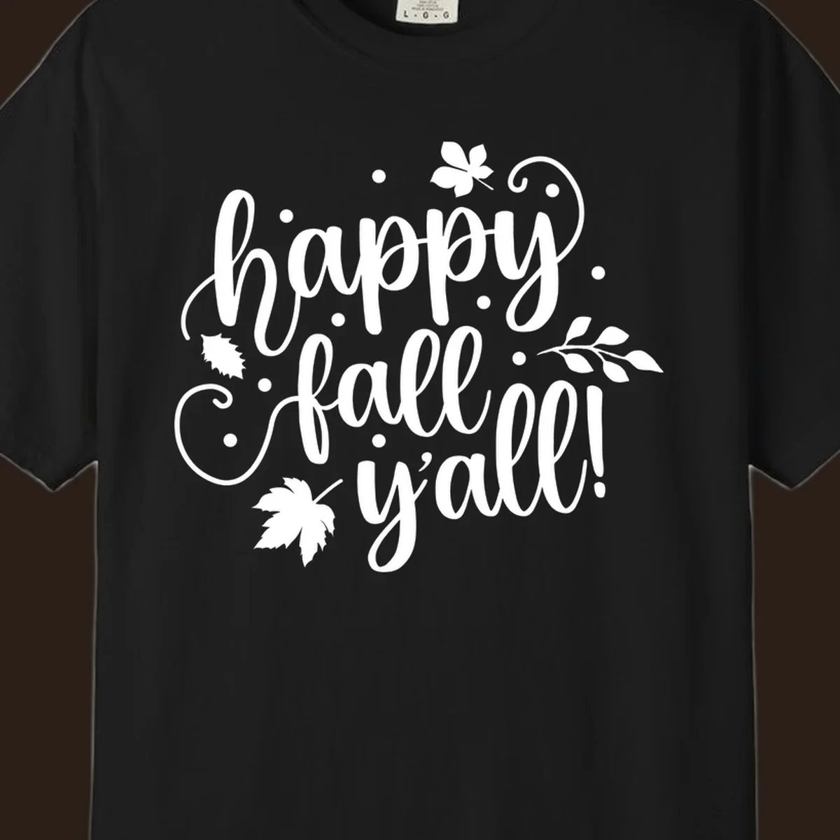 Happy Fall Y'all script design with maple leaves and swirls.
