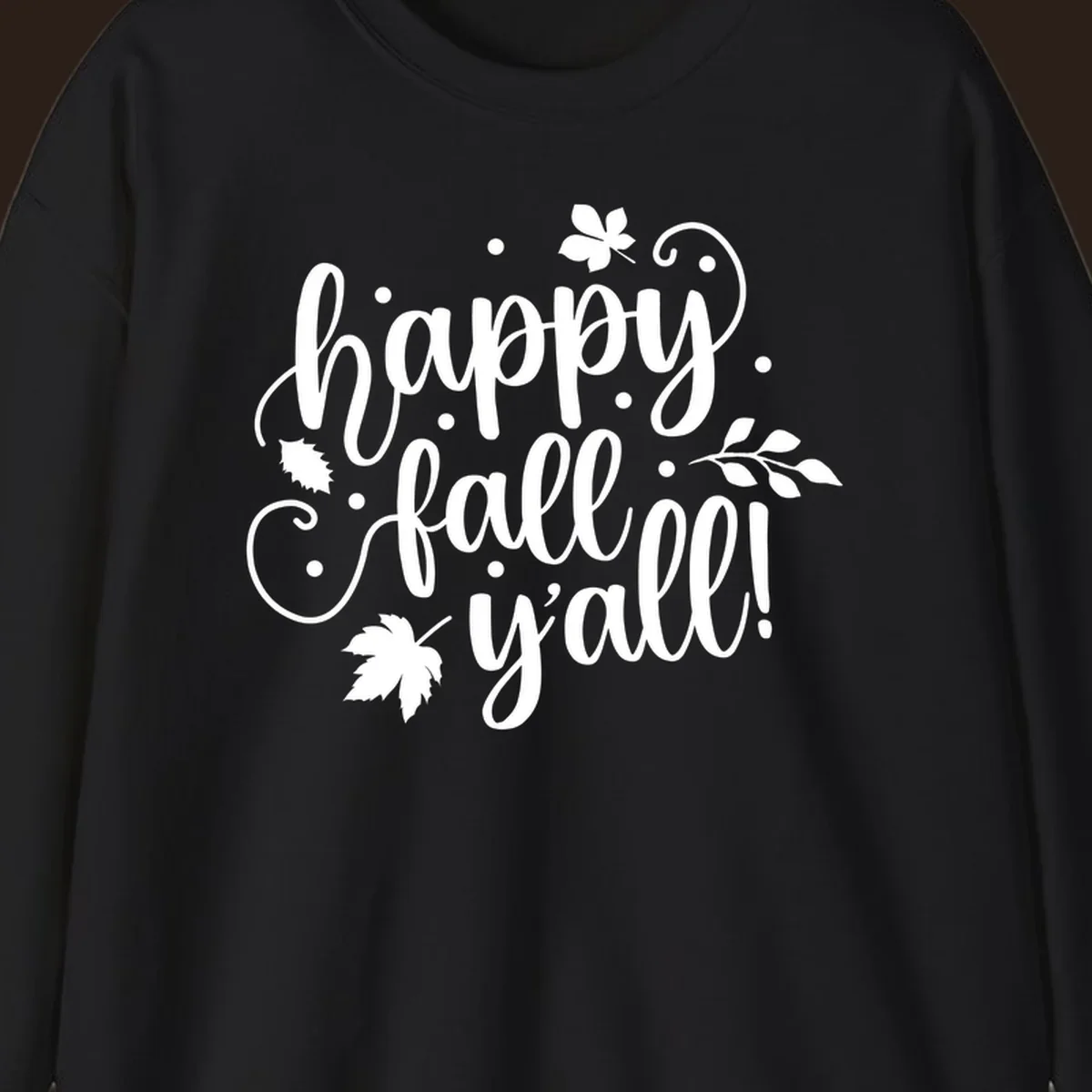 Happy Fall Y'all script design with maple leaves and swirls.