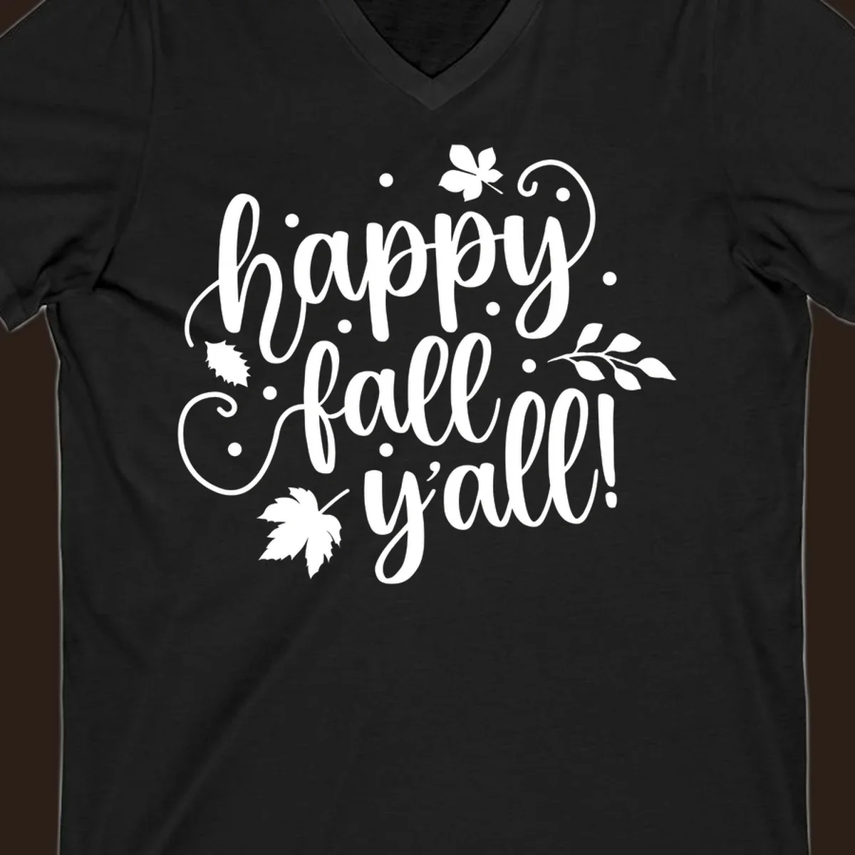 Happy Fall Y'all script design with maple leaves and swirls.