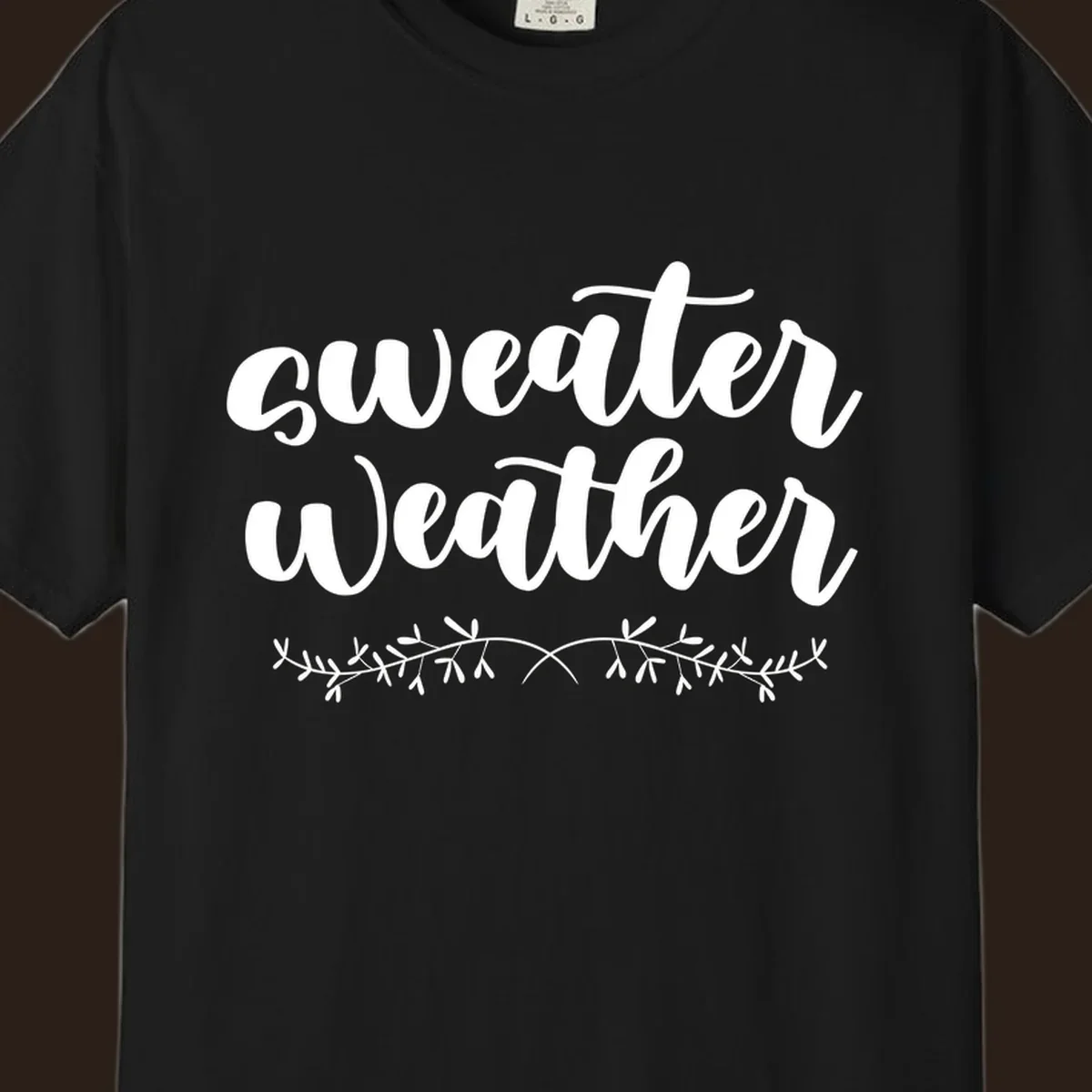 Sweater Weather text in white script font with leafy vine accent.