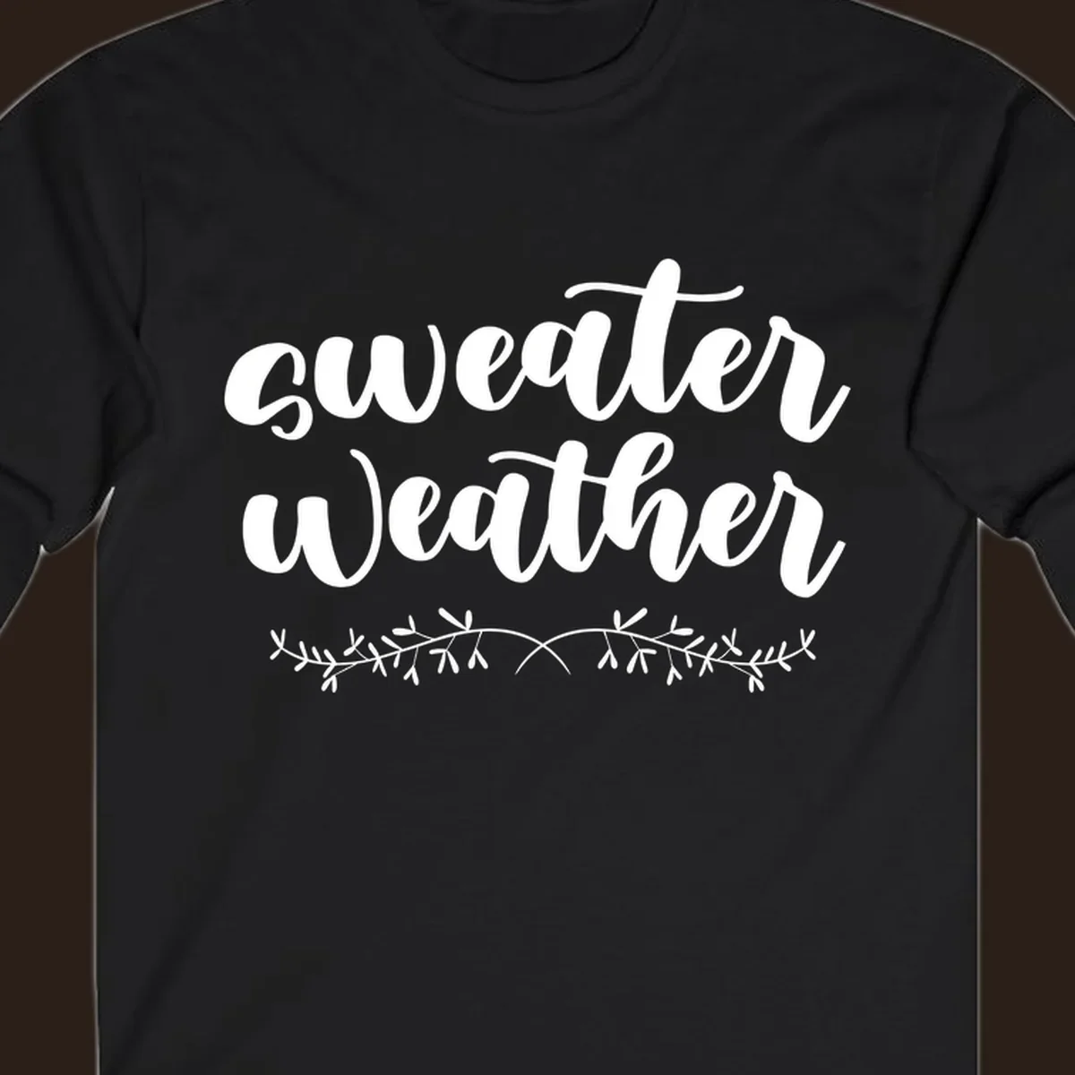 Sweater Weather text in white script font with leafy vine accent.