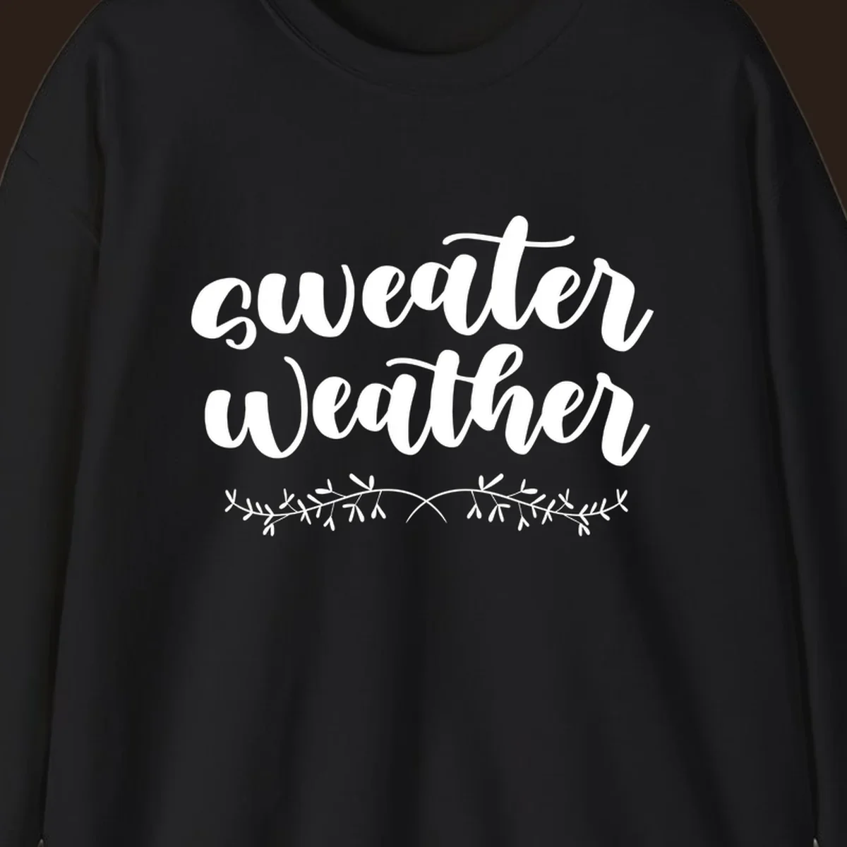 Sweater Weather text in white script font with leafy vine accent.