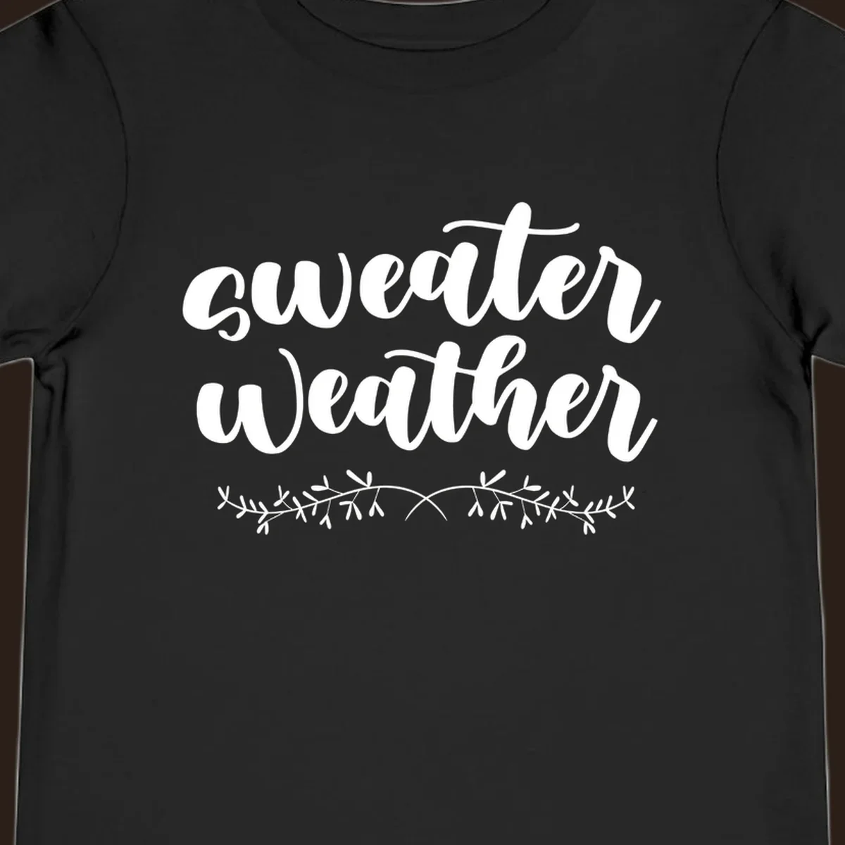 Sweater Weather text in white script font with leafy vine accent.
