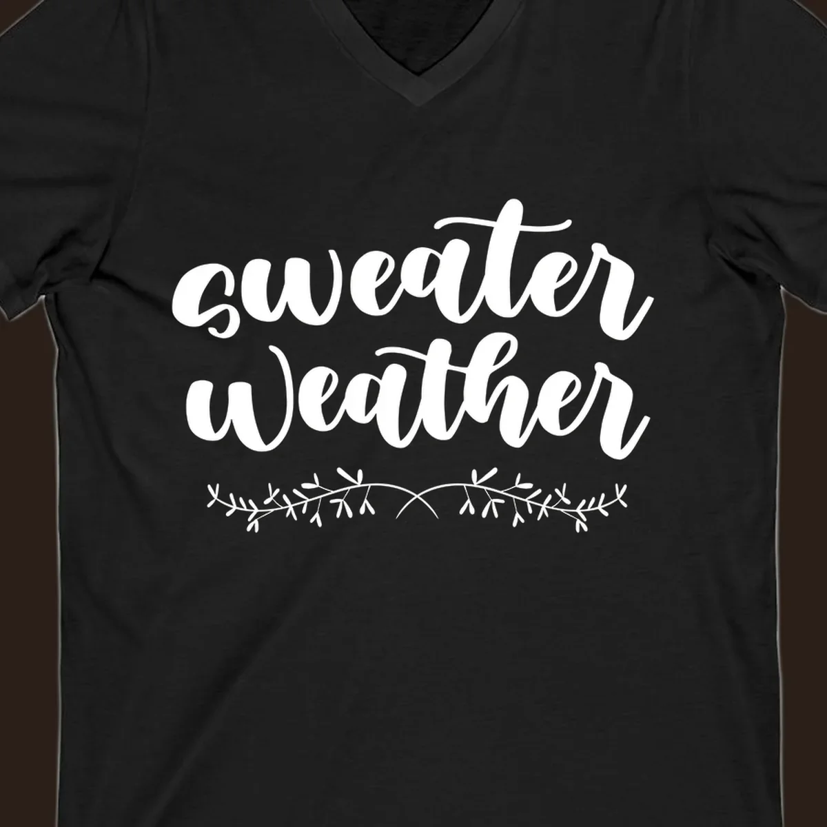 Sweater Weather text in white script font with leafy vine accent.