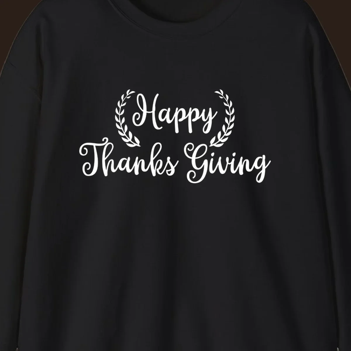 Happy Thanksgiving text with a laurel wreath, in white on black and black on white.