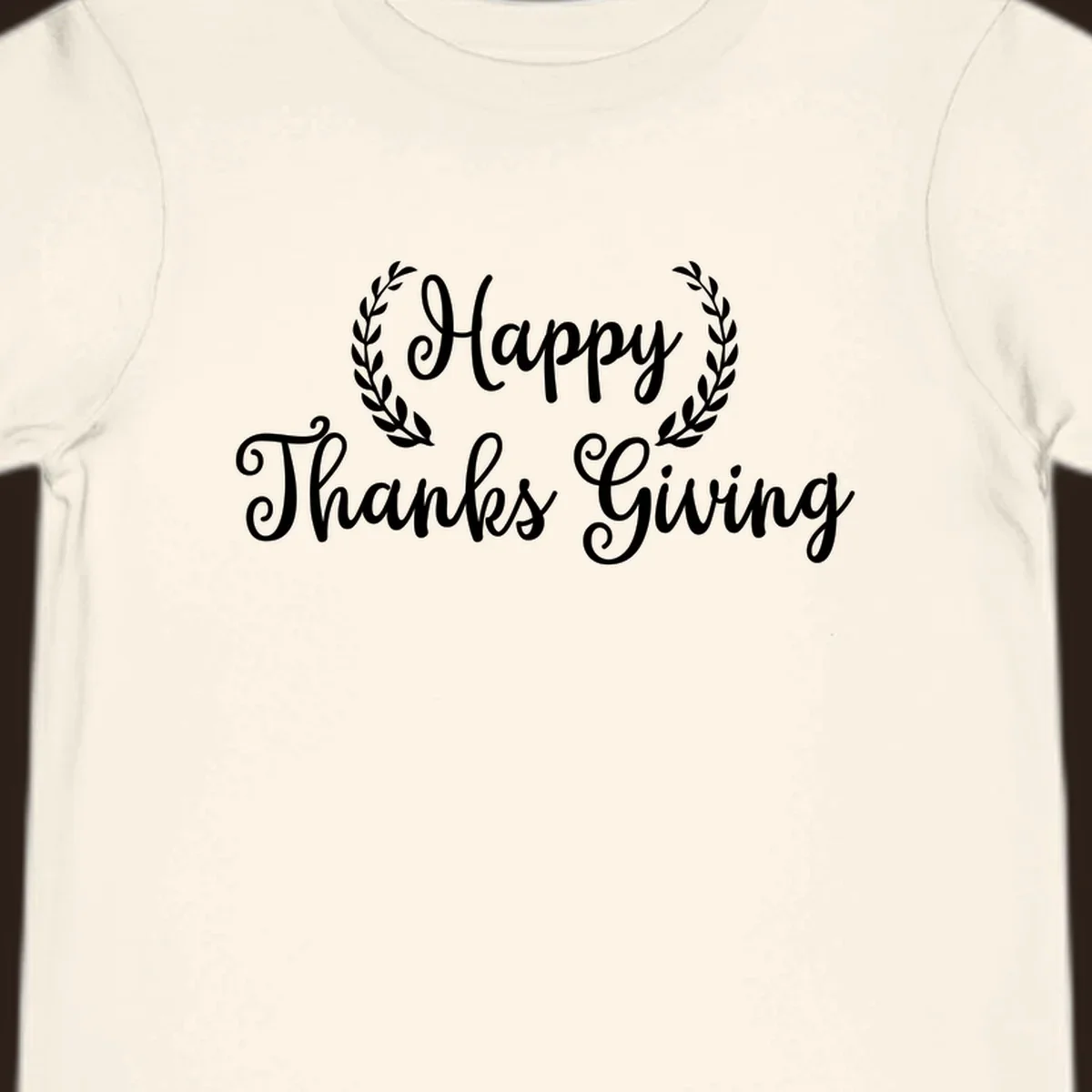 Happy Thanksgiving text with a laurel wreath, in white on black and black on white.