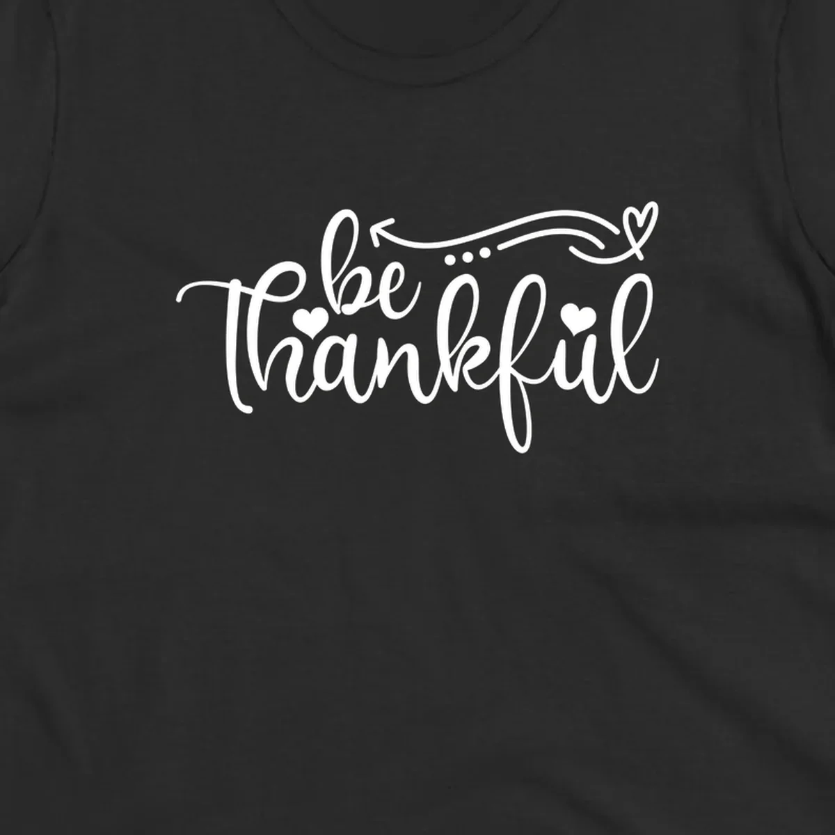 White script text 'be thankful' with hearts and decorative swirls for Thanksgiving.