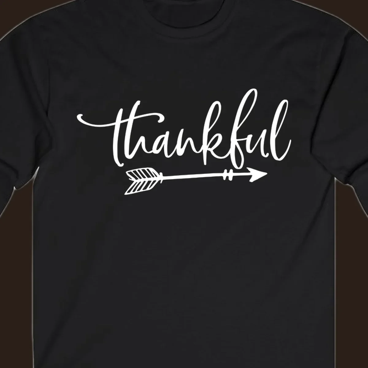 Thankful text with an arrow graphic, Thanksgiving theme.