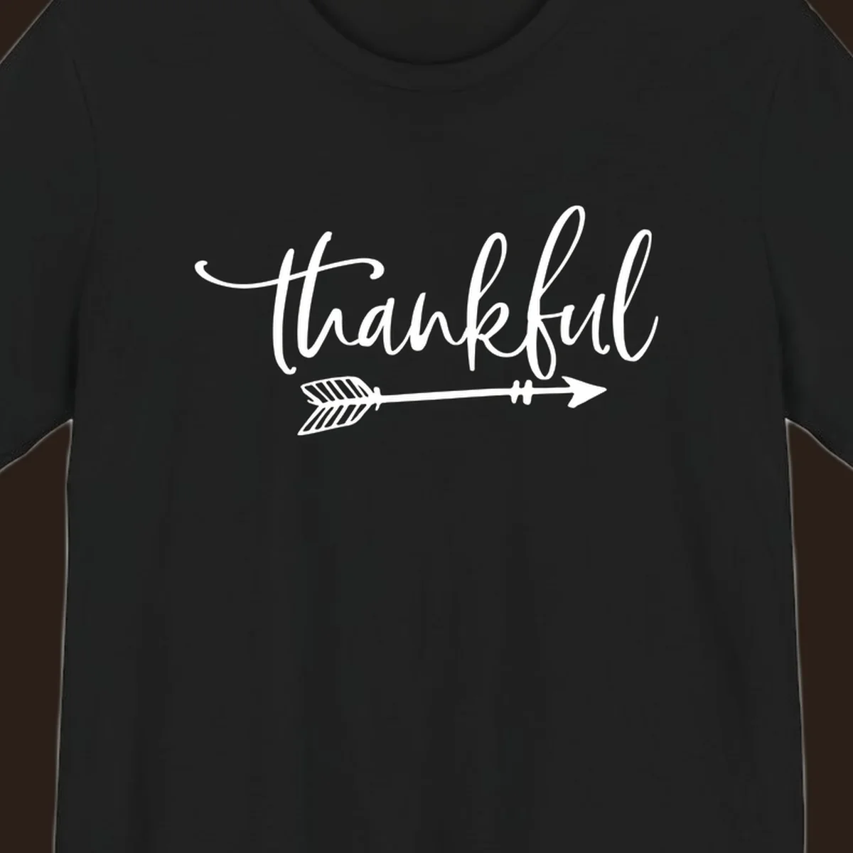 Thankful text with an arrow graphic, Thanksgiving theme.